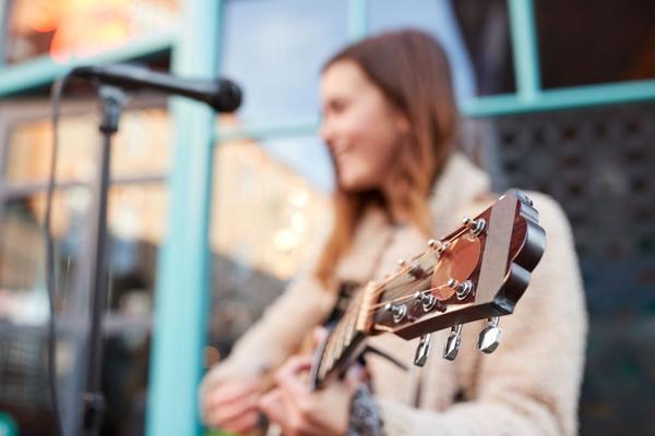 A woman playing guitar