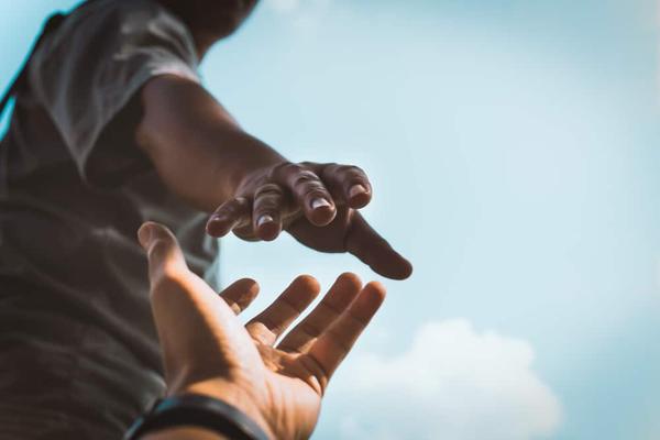 People reaching out their hands