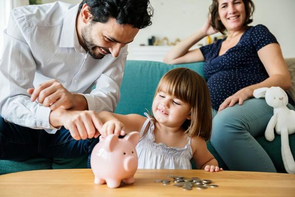A child putting money into a piggy bank