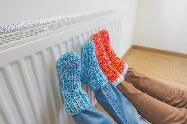 two pairs of feet on a radiator