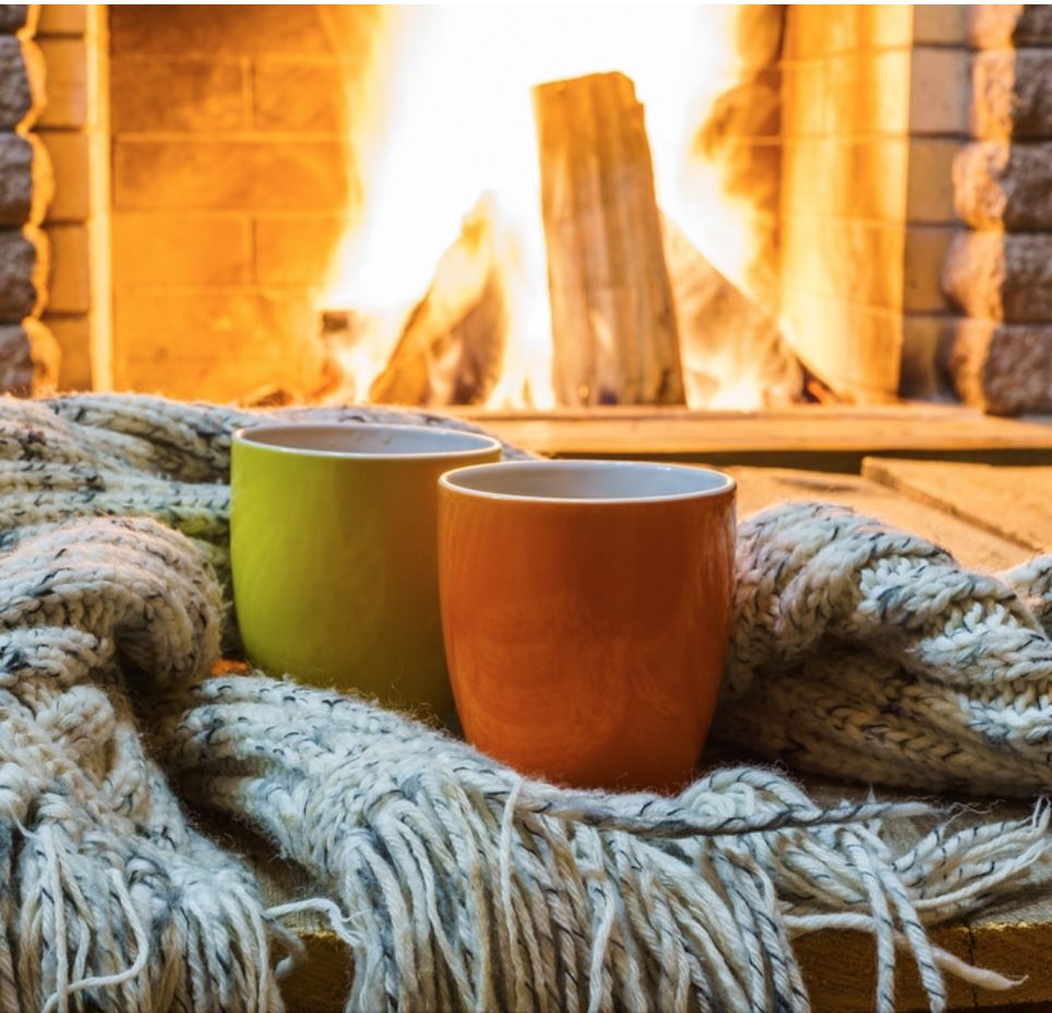 mugs in front of an open fire