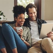 Royal Mint diverse couple sitting on a sofa