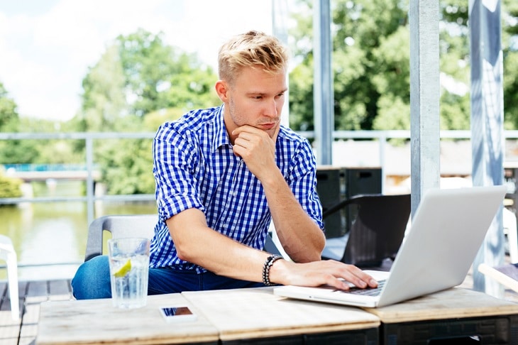 man at laptop covid-19