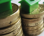 pound coins with small house on top