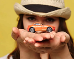 woman holding toy car
