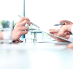 Hands showing a financial consultation over paperwork