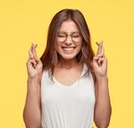 Girl crossing her fingers for luck