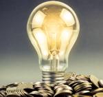A lightbulb on a pile of coins