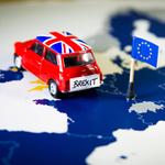 A Mini car on a Europe map with a Union Jack flag