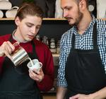 A mentor teaches a young Kickstarter barista