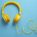 A pair of yellow headphones on blue background