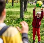 children playing catch in a park
