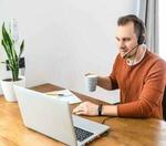 Man with a headset working from his home desk