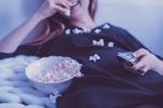 a person eating popcorn