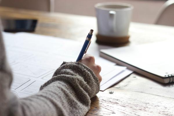 Person writing on paper