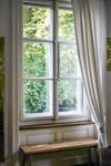 window with curtains and a reading bench