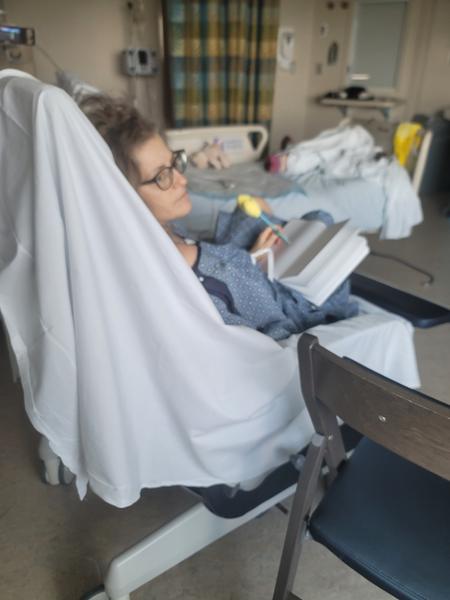 Jennie continuing drawing, with her left hand, looking out the window in the neurology department