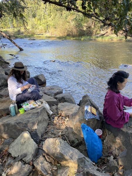 Students beginning to paint along the banks of the Eno