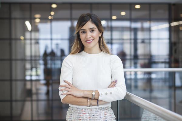 smiling woman with arms folded