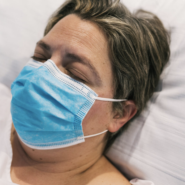 Woman sleeping on a hospital bed