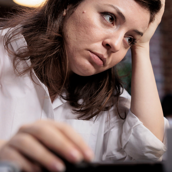 Tired Employee Sitting at Desk