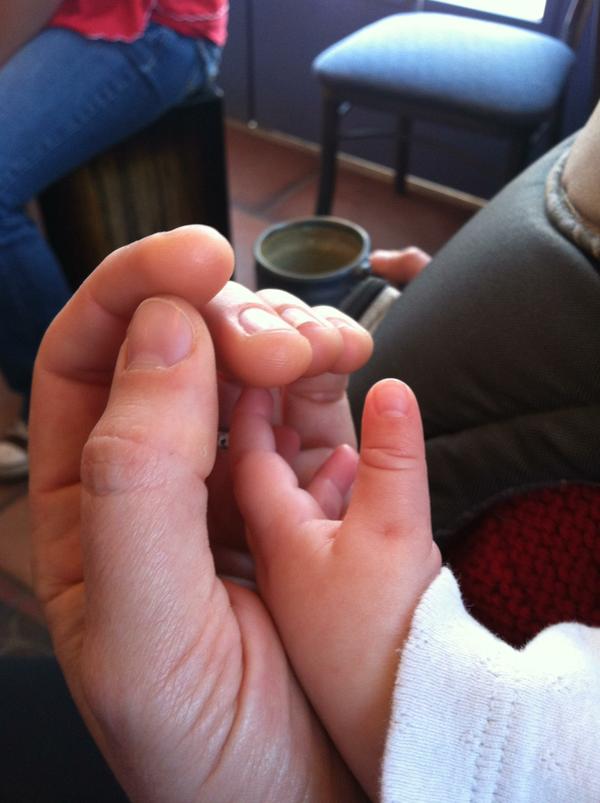 Man holding baby hand