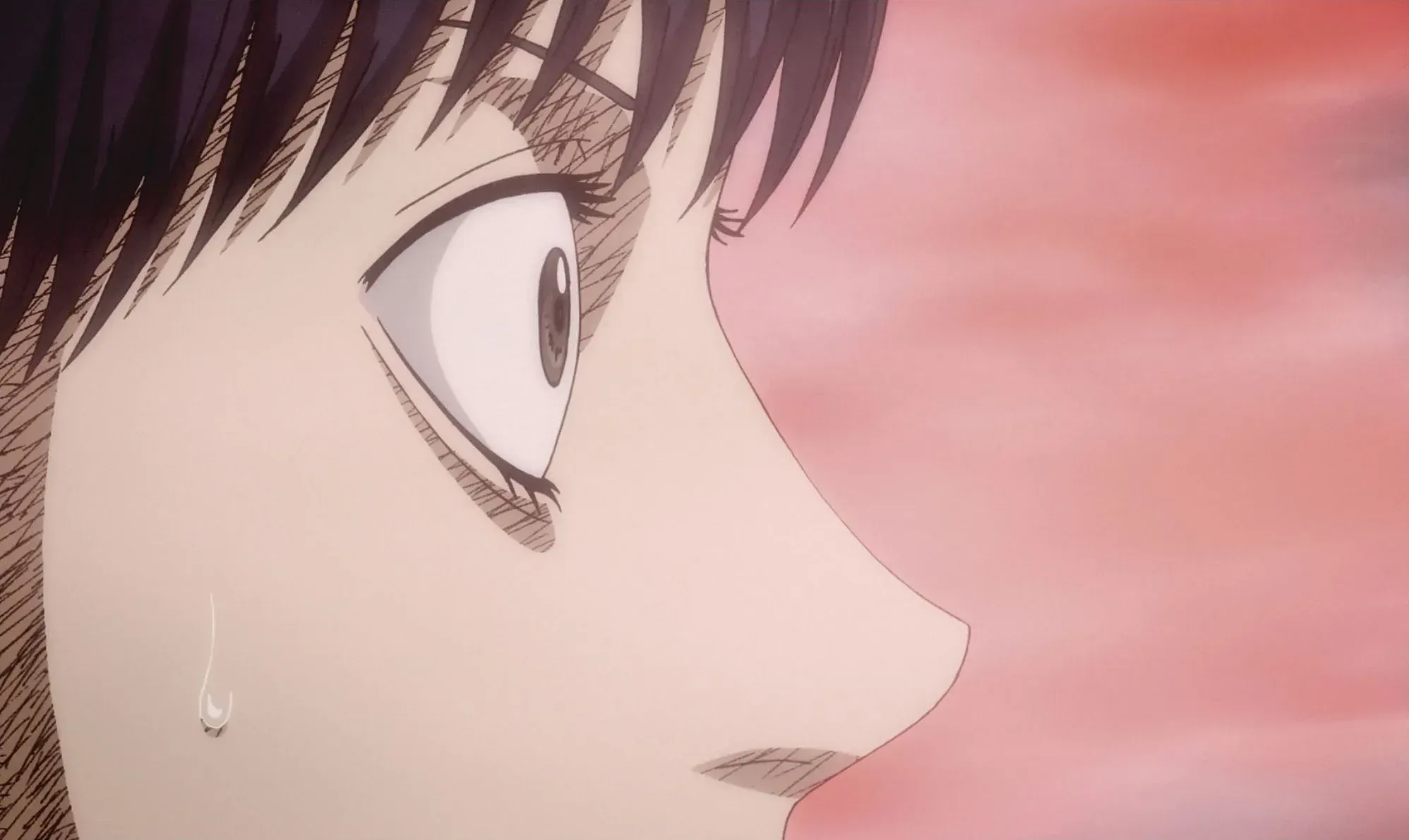 Anime still of a character in profile shedding a single tear against a pink sky
