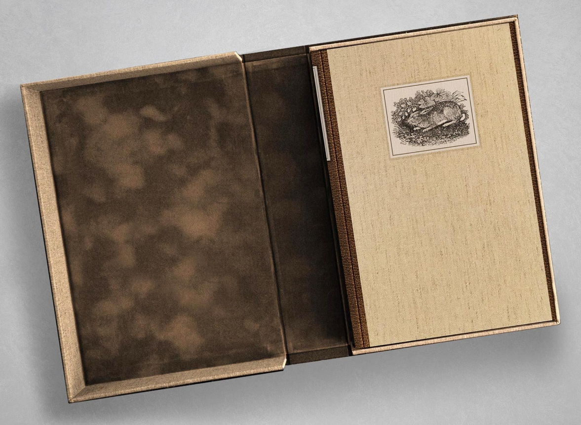 Of Mice and Men from Suntup Editions: natural linen-cloth binding with leather spine and an inset engraving of a rabbit, set in an open velvet-lined clamshell box