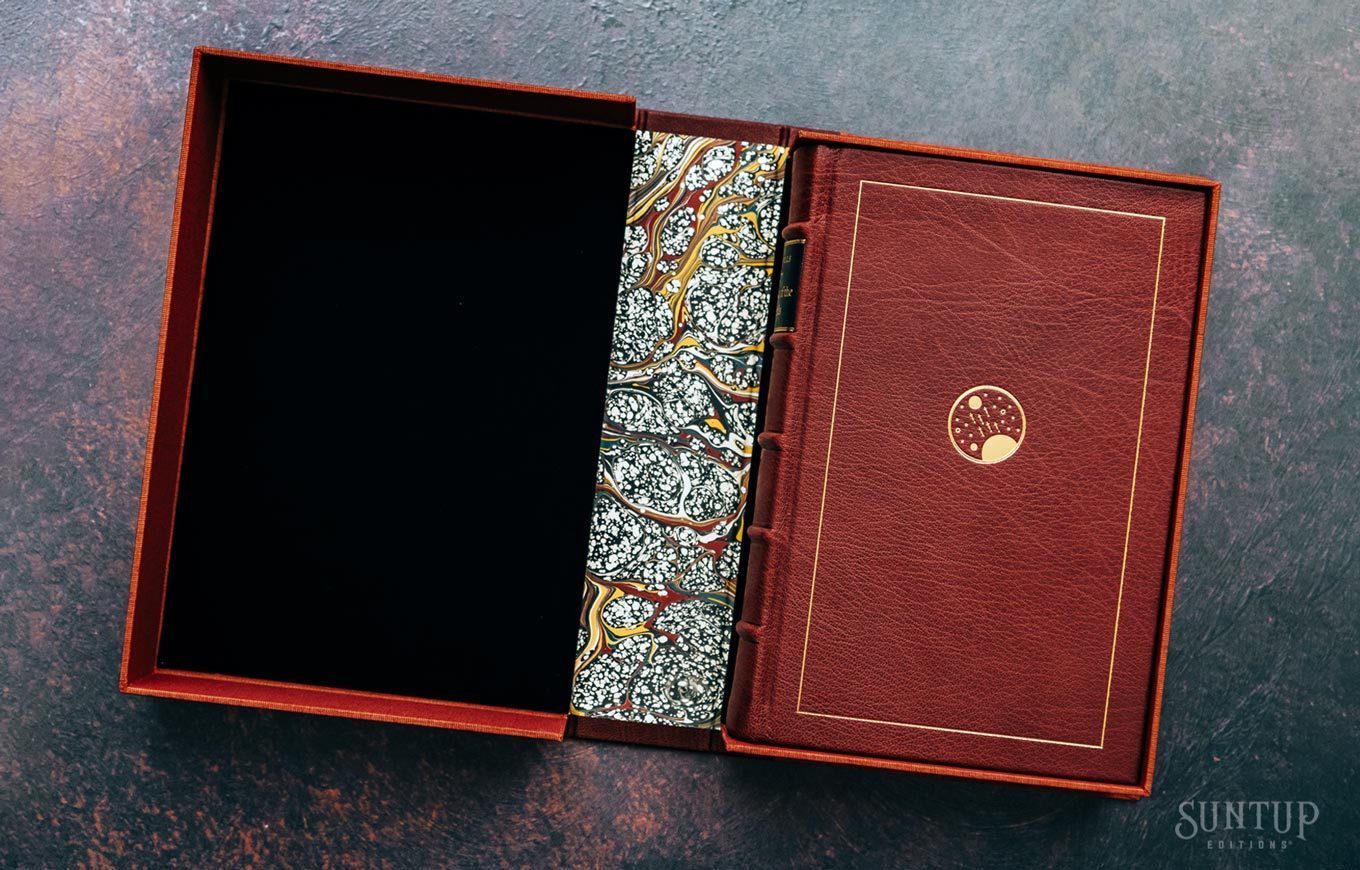 The War of the Worlds lettered edition from Suntup Editions: oxblood leather binding with a gilt planet emblem and gilt rule, raised spine bands, and marbled board, set in its cloth-lined clamshell box