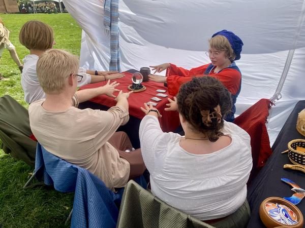 2025 Utah Renaissance Faire - youth guiding in a story fortune telling