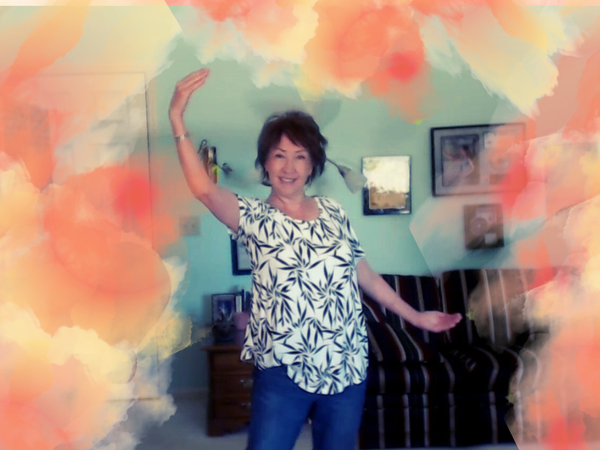 Vocal coach Judy Rodman with arms wide demonstrating wider vocal range