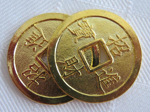 Two gold I Ching coins