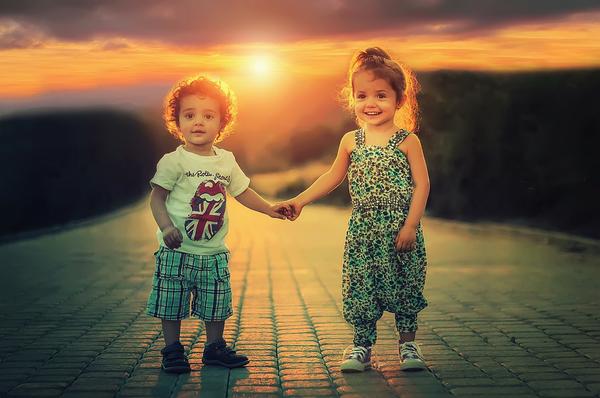 Happy children on path with sunset