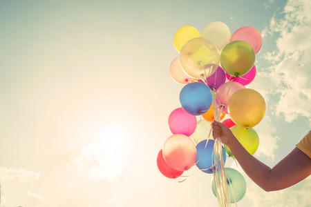 Girl Holding Balloons