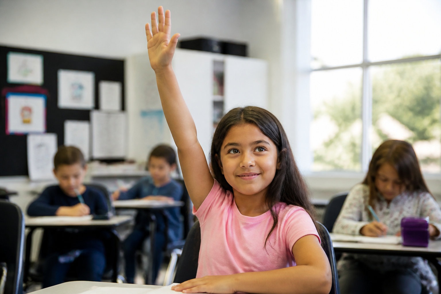 A girl confidently raising her hand in class