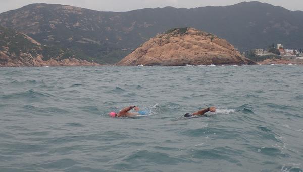 Two swimmers in rough water in Hong Kong