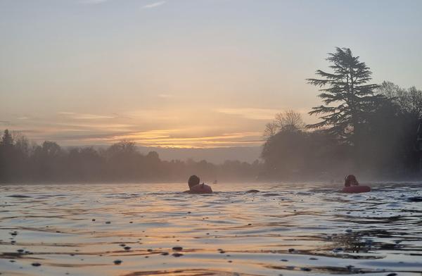 2 people swimming in a river