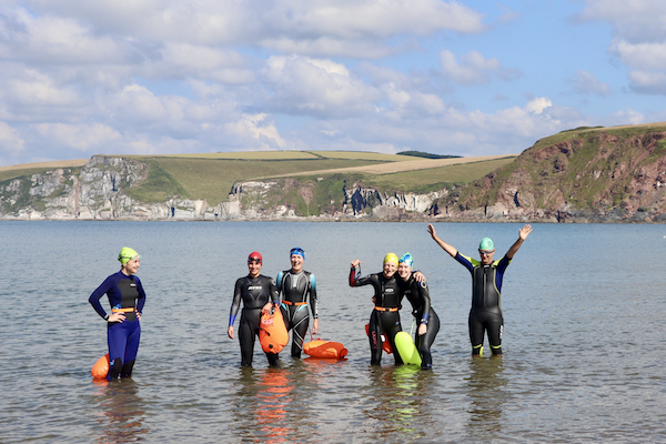 Group of swimmers waving in sea