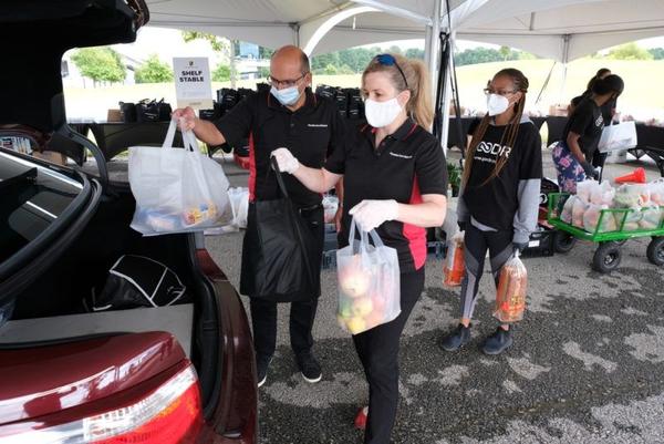 Porsche Team Handing Out Food