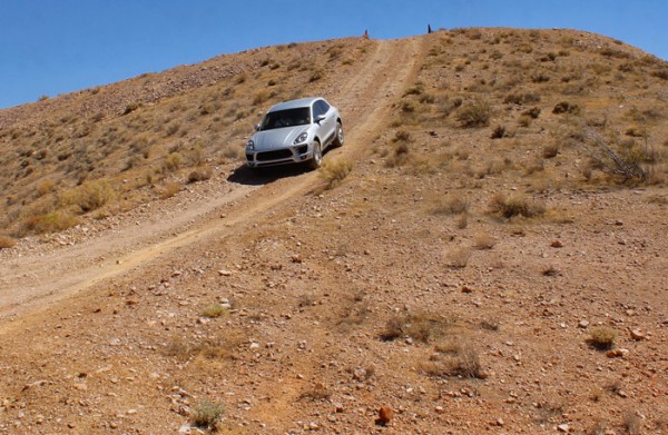 Porsche macan driving down an off-road hill