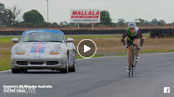 cyclist races porsche
