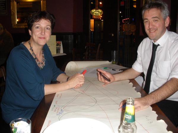 Heide and Iain when they were younger, at a table 