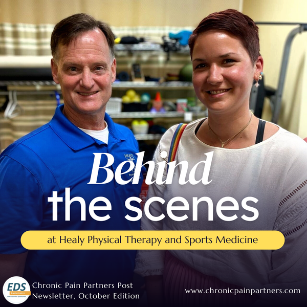 Two people in a physical therapy office. A man with short brown hair and a blue shirt stands next to a woman with short brown hair and a white shirt. They
both smile. Text: Behind the scenes at Healy Physical Therapy and Sports Medicine.
