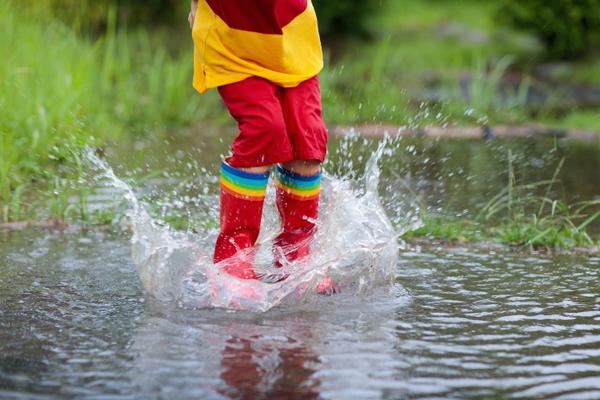 John Ruskin quote with photo of child wearing red boots and playing in water