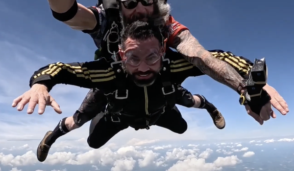 Attorney Greg McIntyre and his tandem instructor skydiving. 