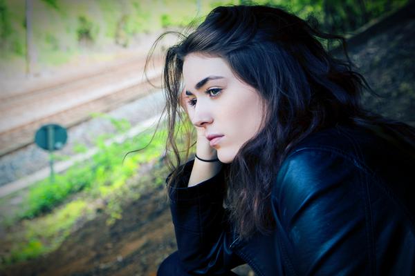 a woman alone near a railroad