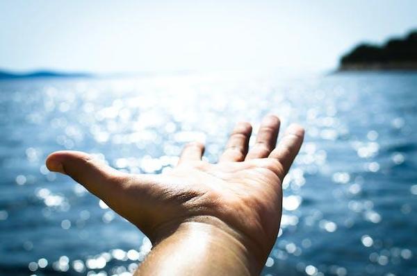 Photo by Lukas: https://www.pexels.com/photo/person-hand-reaching-body-of-water-296282/