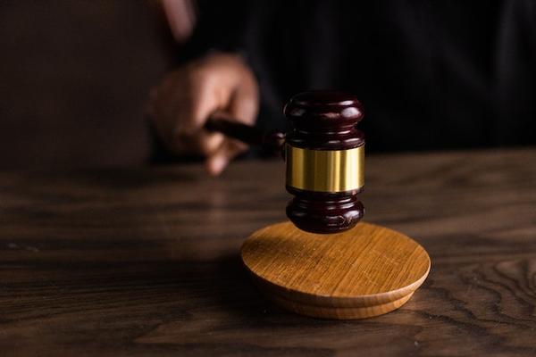 Photo by EKATERINA  BOLOVTSOVA: https://www.pexels.com/photo/brown-wooden-gavel-on-brown-wooden-table-6077326/