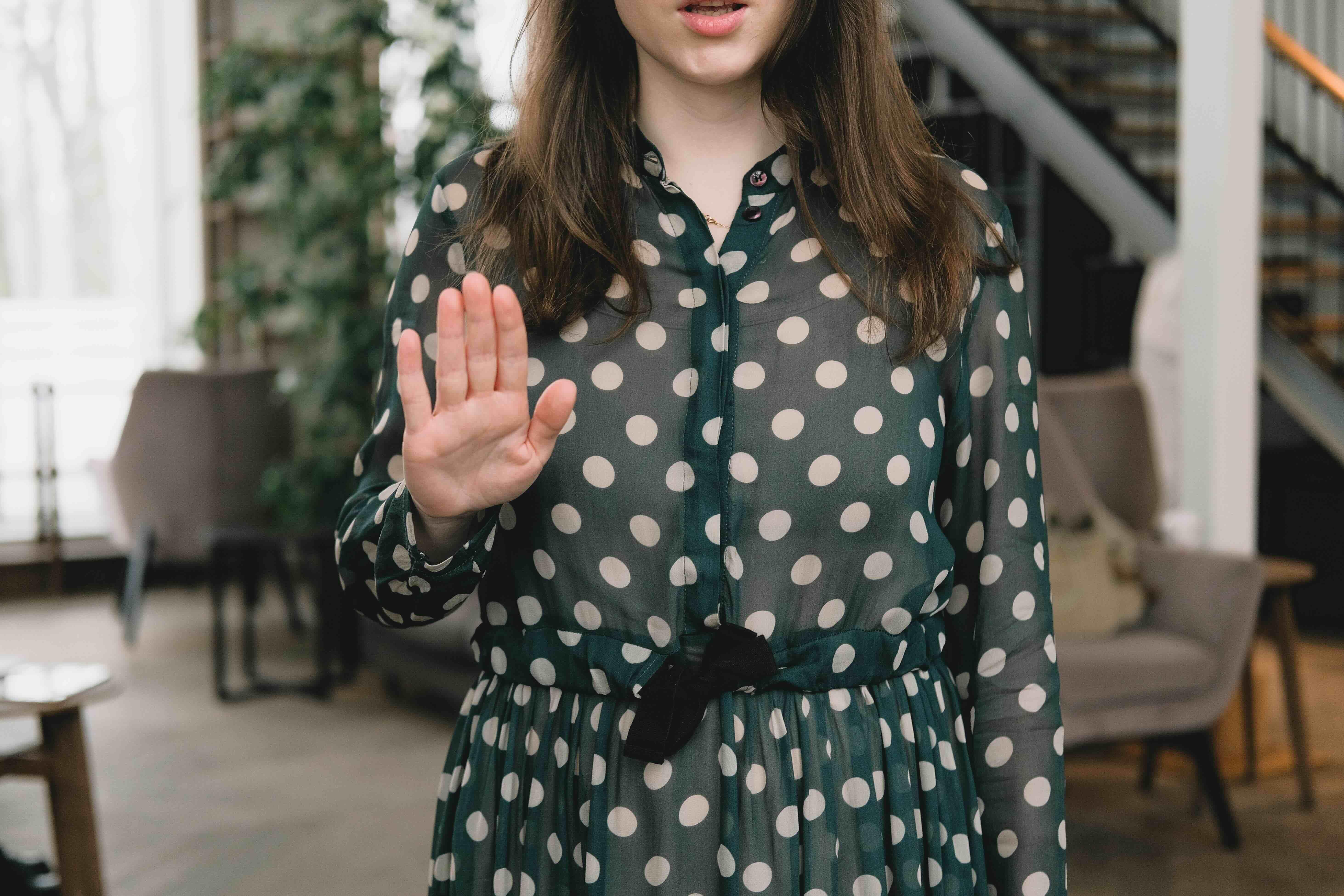 Photo by SHVETS production: https://www.pexels.com/photo/crop-feminine-woman-showing-stop-gesture-in-modern-apartment-7516245/