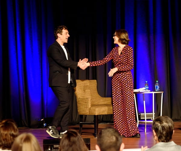 Ann and BJ Novak greeting on stage